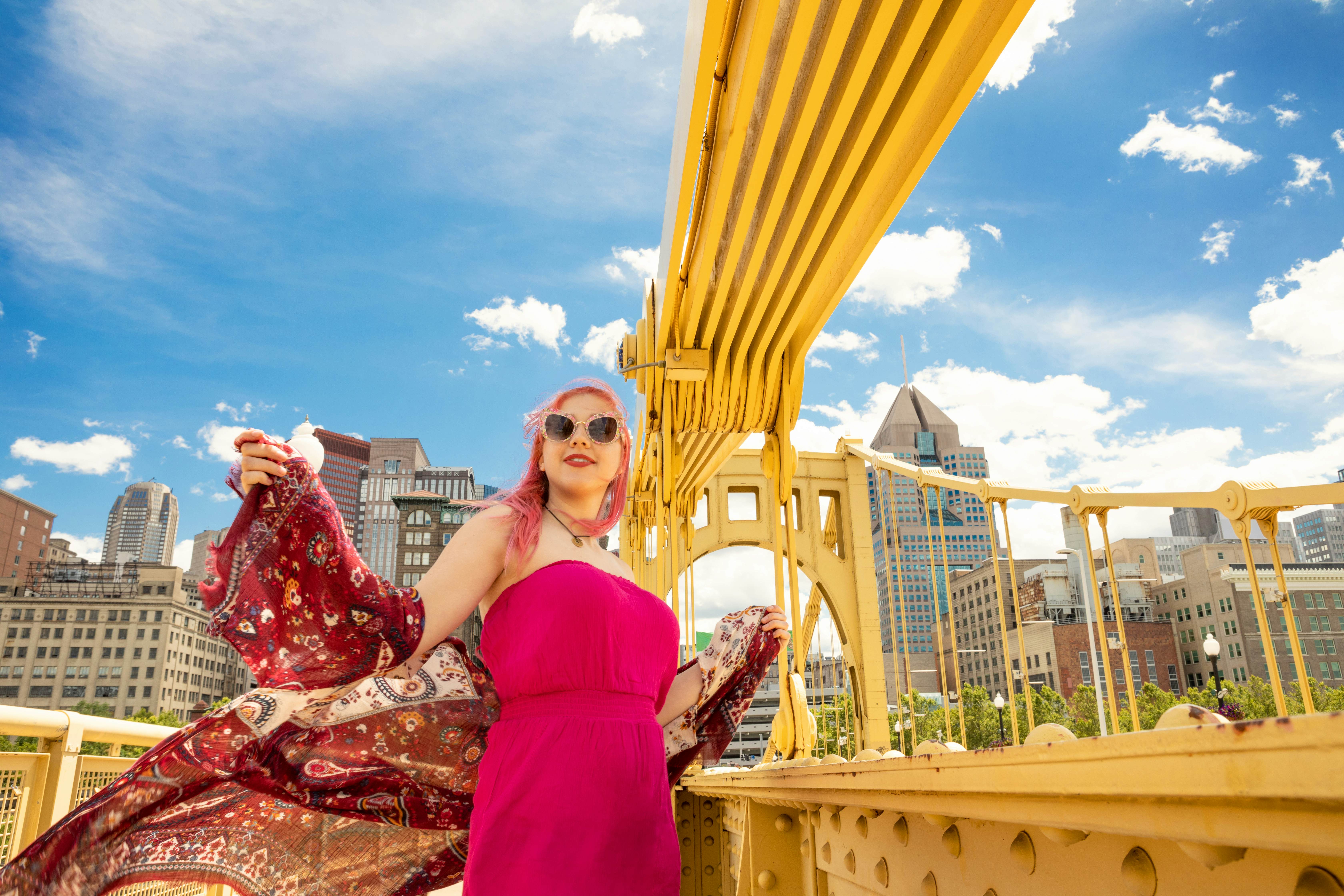 A beautiful 17 year old girl with pink hair enjoying a rare sunny day on the Roberto Clemente Bridge in downtown Pittsburgh, PA, USA.